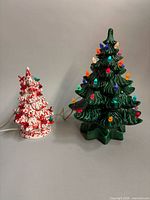 Both ceramic Christmas trees side by side showing size difference and cords