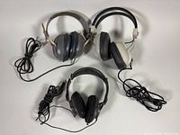 All three headphone pairs laid out showing overall condition