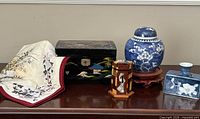Group shot showing all five items: ginger jar on stand, lacquer jewelry box, mother of pearl toothpick holder, signed vase, Tokyo National Museum handkerchief