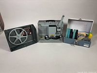 Projector front, detachable cover with reel, storage box with reels
