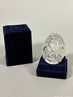 Crystal egg beside two-piece velvet box