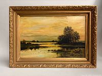 Framed oil landscape painting in ornate gilt frame