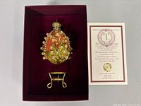 Egg with stand in velvet-lined box alongside COA