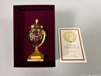 Egg in presentation box next to COA card