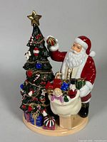 Full view of figurine showing Santa, tree, base