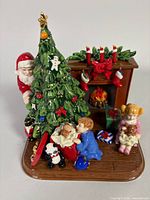 Front angle view showing entire porcelain Christmas Morning figurine with Santa, tree, children, fireplace