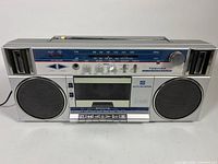 Front view of Toshiba RT-140S boombox showing speakers, tuner scale, controls, cassette deck