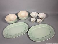 Full set showing two green platters, two green bowls, two Basket bowls and two Basket ramekins