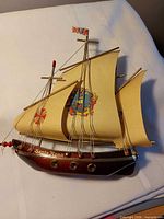 Front view of Santa Rosa model ship showing sails, hull markings and rigging