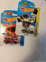 Both sealed Hot Wheels cars on cards