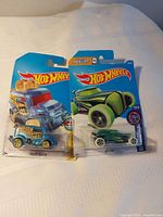 Both Hot Wheels cars in original packaging side by side