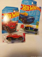 Both packaged Hot Wheels cars front view