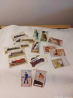 All 20 cigarette cards spread out on cloth background