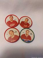 Front view of four Quaker NHL Lucky Coin discs