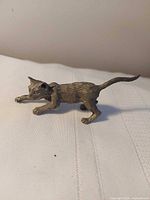 side view of pewter cat figurine showing stance and detail