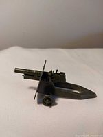 Left side view showing overall structure, shield, barrel, trail and wheel hubs