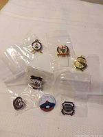 All seven curling pins in plastic sleeves on cloth
