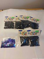 seven sequin packs, six black Miracle packs, one purple/blue bag