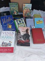 Group shot of all fourteen books arranged on cloth