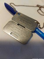 Front view showing engraving of both dog tags and chain