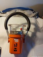 Front view of CP Rail orange lantern showing logo and handle