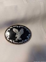 Front view of oval belt buckle showing eagle design