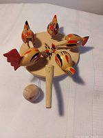 Top view showing five chickens on disc and paddle handle