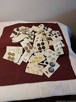 Group of unopened button cards spread on fabric