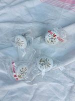 Four packaged floral ceramic knobs
