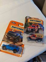 Front view of both blister-packaged Matchbox vehicles
