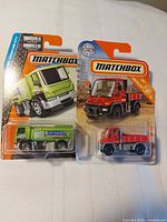 Front view of both sealed Matchbox vehicles on blister cards