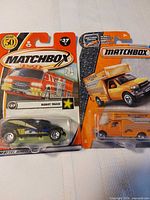 Front view of both Matchbox vehicles in packaging