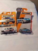 Front view of both sealed Matchbox vehicles on blister cards