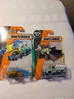 Front view of both Matchbox vehicles in packaging