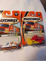 Front view of both Matchbox vehicles in packaging