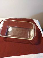 Top view of clear Pyrex glass loaf pan showing rectangular shape and handles