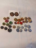 Group shot of all decorative buttons arranged on fabric