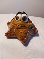 front view showing starfish shape, eyes, glaze