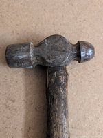 Overall view of hammer head showing flat face and rounded peen