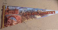 Full view of triangular pennant with scenic print and Color Country text