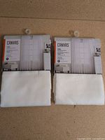 Two sealed packs of CANVAS voile window panels front view