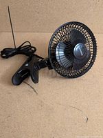 Full view of black clamp fan showing clamp, head and power cord