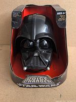 Front view of Darth Vader voice-changer helmet in box