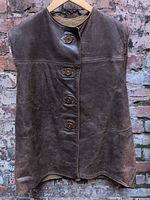 Front view of brown leather jerkin vest on hanger