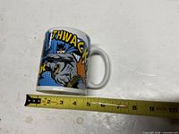 Side view showing Batman graphic and ruler for scale
