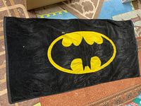 Full view of black towel with yellow Batman emblem