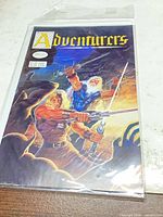 Front cover of Adventurers #1 comic book sealed in plastic sleeve showing title, issue number and price