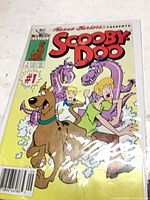 Front cover of bagged "Scooby-Doo" Issue #1 comic showing characters and condition