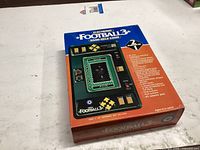 Front of boxed Electronic Football 3 handheld game