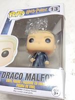 Front view of boxed Draco Malfoy Funko Pop showing figure and product name